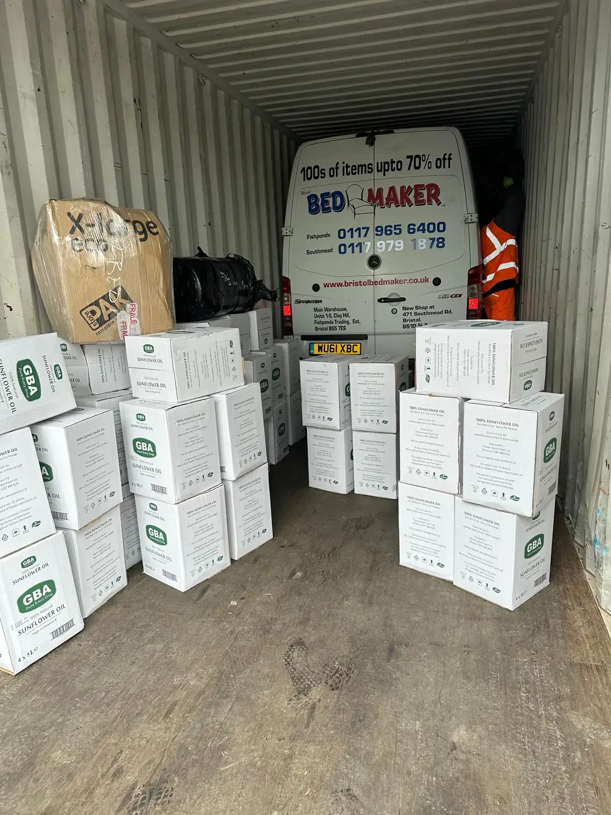 A transit van being loaded with customer goods in the UK bound for Lagos